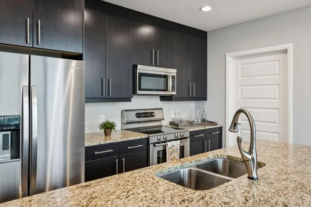 a living room with furniture a large window and a flat screen tv
