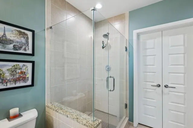 a bathroom with a tub a sink and a large mirror