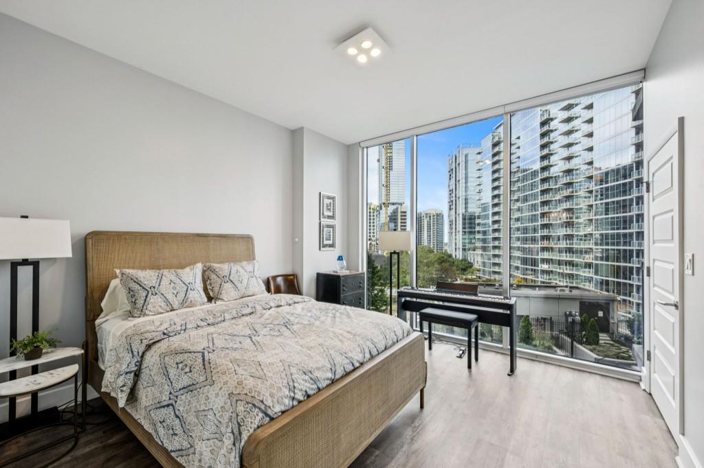 1080 Peachtree Street Northeast, Unit 1012 Atlanta, GA 30309 - Photo 23 of 46 a bedroom with a bed and a chandelier