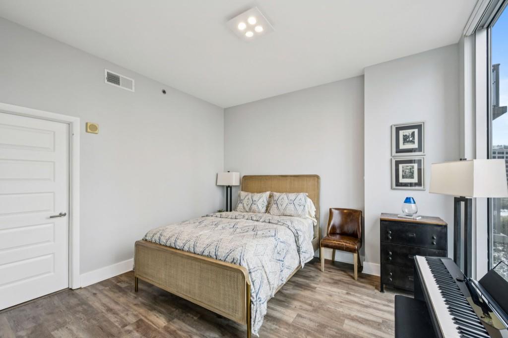 1080 Peachtree Street Northeast, Unit 1012 Atlanta, GA 30309 - Photo 24 of 46 a bed room with a bed and a lamp