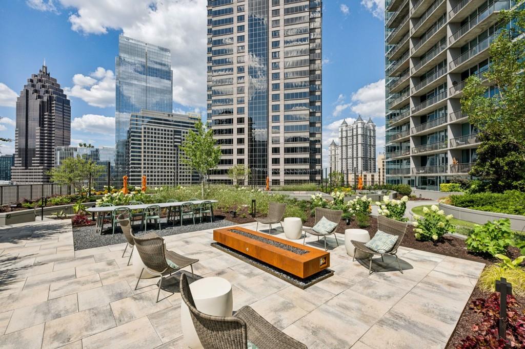 1080 Peachtree Street Northeast, Unit 1012 Atlanta, GA 30309 - Photo 31 of 46 a view of a patio with couches and a fire pit