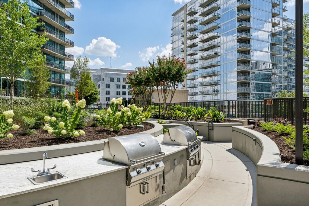 1080 Peachtree Street Northeast, Unit 1012 Atlanta, GA 30309 - Photo 32 of 46 a view of a swimming pool with outdoor seating and plants