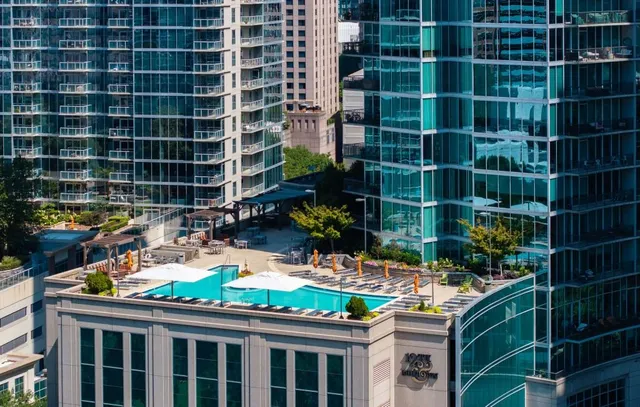 a room with lots of flowers and a glass door