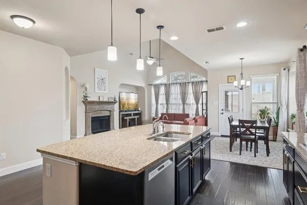 a large kitchen with a table and chairs