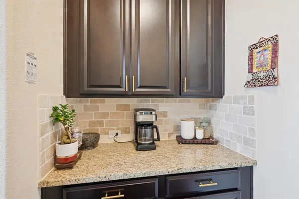 a kitchen with a granite countertop potted plant on the granite countertops