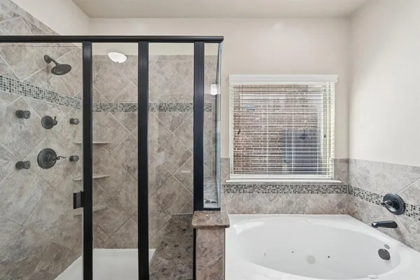 a bathroom with a bathtub and a shower
