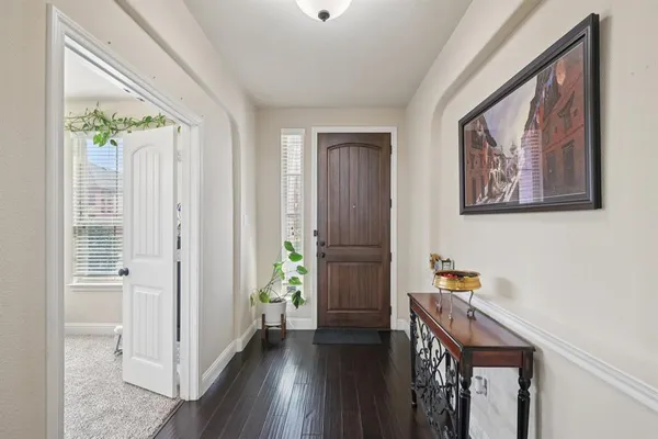 a view of hallway with wooden floor and stairs