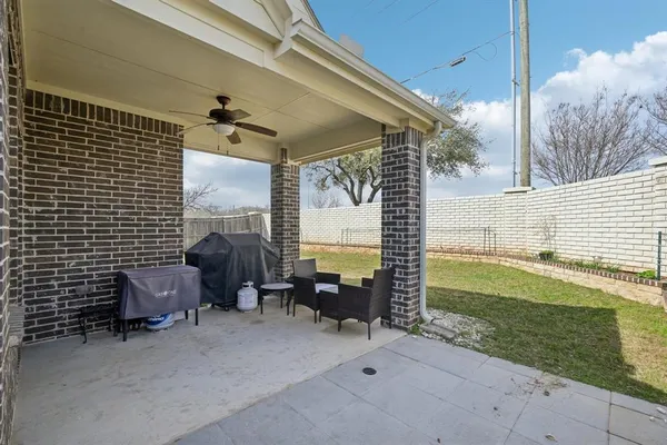 a view of a patio with table and chairs and potted plants