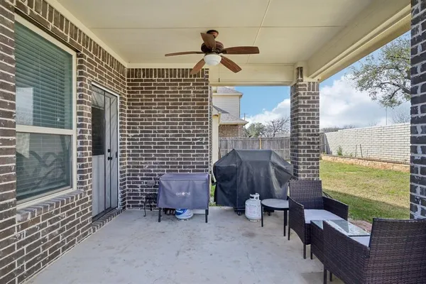 a backyard of a house with outdoor seating