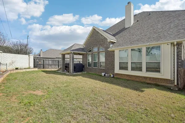 a front view of a house with a garden and pathway