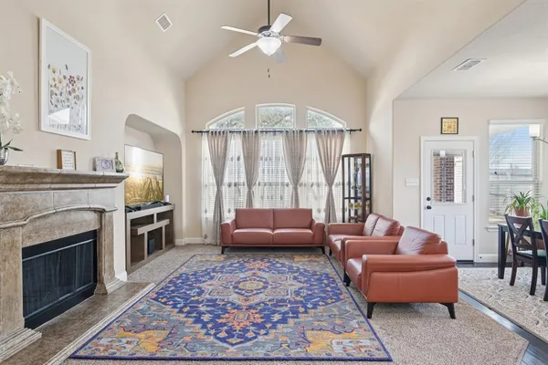 a living room with furniture and a fireplace