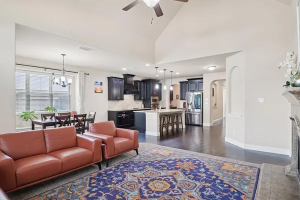 a living room with furniture wooden floor and a chandelier