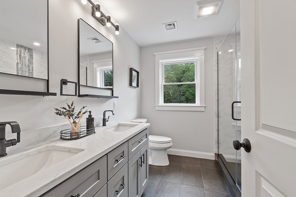 15-2 Park Street, Unit B North Reading, MA 01864 - Photo 13 of 39 a bathroom with a sink a toilet and a mirror