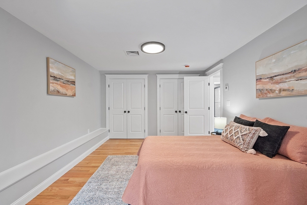 15-2 Park Street, Unit B North Reading, MA 01864 - Photo 22 of 39 a bedroom with a bed and a painting on the wall