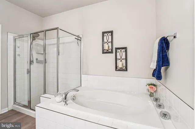 a bathroom with a double vanity sink mirror and shower