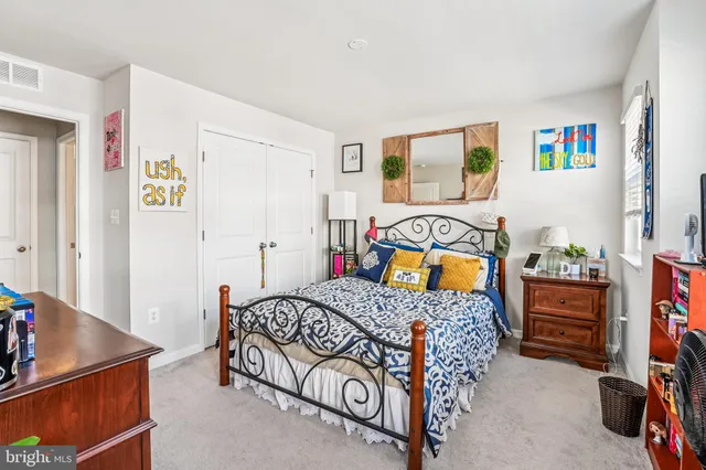 a bedroom with a bed and a closet