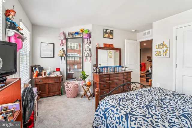a bedroom with furniture and a flat screen tv