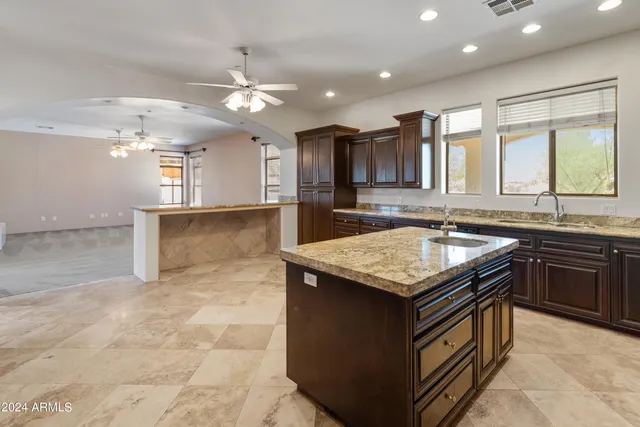 a spacious bathroom with a granite countertop sink and a mirror