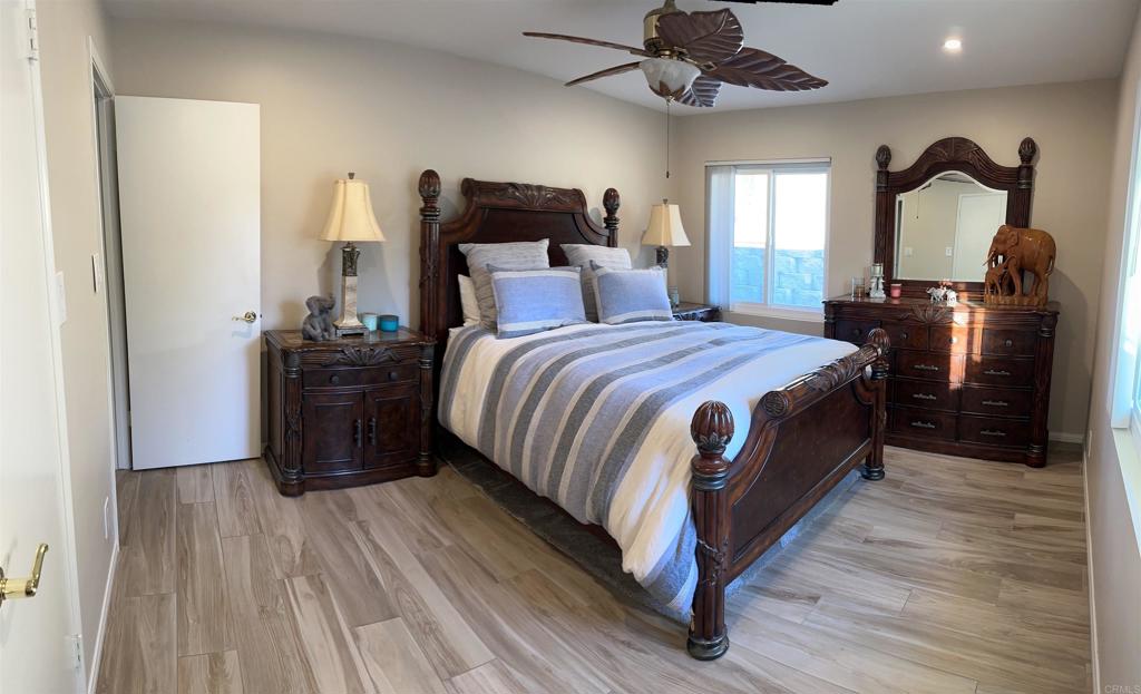 1001 Riverview Drive Fallbrook, CA 92028 - Photo 13 of 36 a bed room with a bed and a chandelier