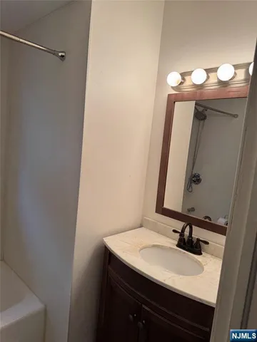 a bathroom with a sink vanity and a mirror