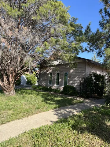 a view of a backyard with sitting area
