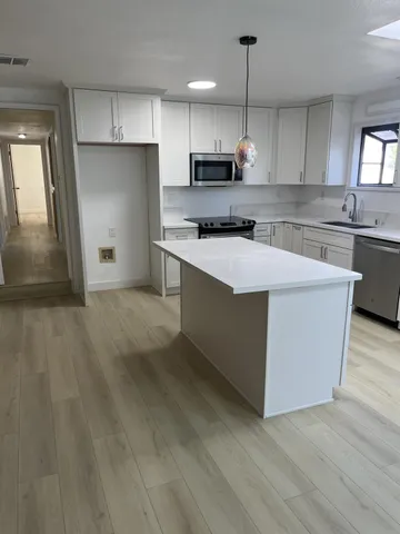 a bathroom with a sink vanity and mirror