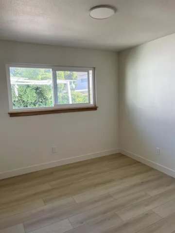 a kitchen with stainless steel appliances kitchen island granite countertop a sink dishwasher stove and oven with wooden cabinets