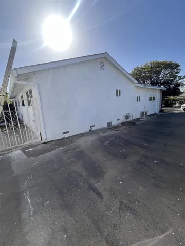 front view of house with potted plants
