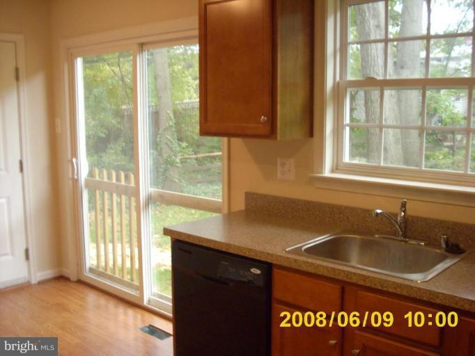 5628A Oakland Road, Unit A Halethorpe, MD 21227 - Photo 1 of 6 a kitchen with a sink window and cabinets