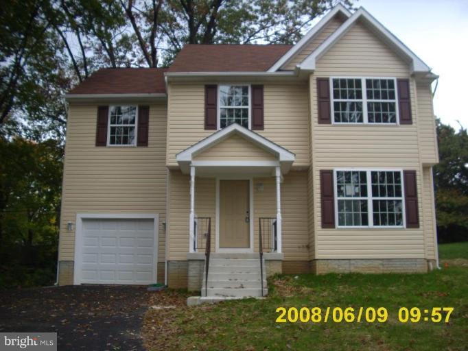 5628A Oakland Road, Unit A Halethorpe, MD 21227 - Photo 3 of 6 a front view of a house with a yard and garage