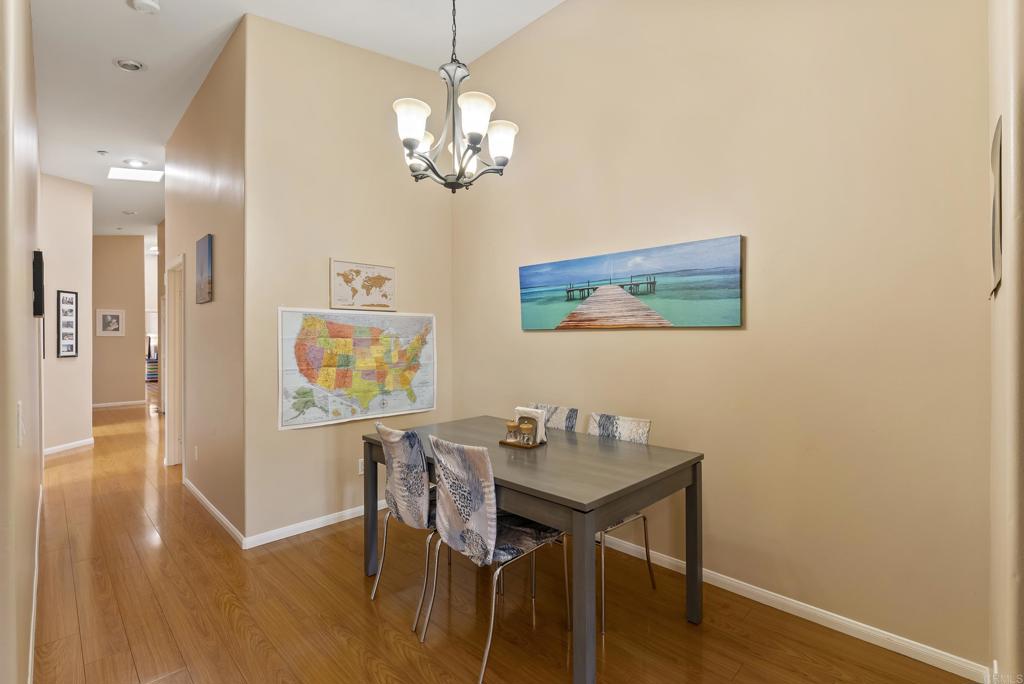 535 F Avenue, Unit 4 Coronado, CA 92118 - Photo 13 of 48 a view of a dining room with furniture wooden floor and a chandelier