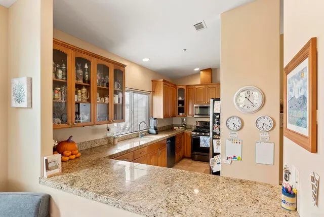 a view of a patio with table and chairs under an umbrella