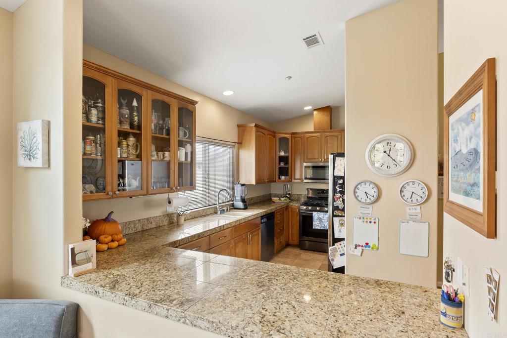 535 F Avenue, Unit 4 Coronado, CA 92118 - Photo 18 of 48 a view of a kitchen with a stove and a window