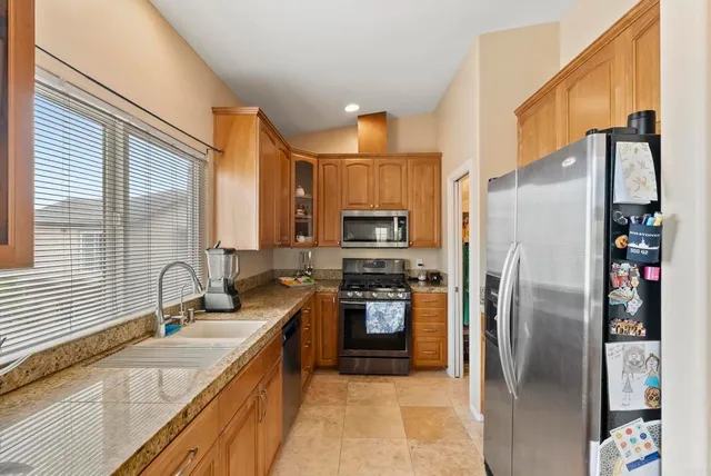 a large bedroom with a bed and large flat tv screen on the dresser