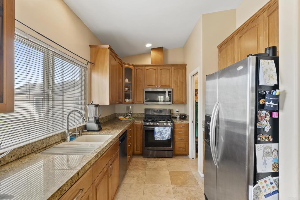 535 F Avenue, Unit 4 Coronado, CA 92118 - Photo 21 of 48 a kitchen with stainless steel appliances granite countertop a refrigerator a stove and a sink