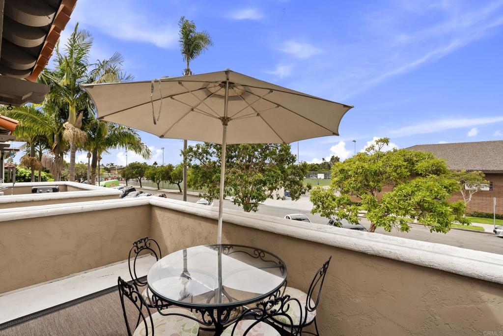 535 F Avenue, Unit 4 Coronado, CA 92118 - Photo 25 of 48 a view of a patio with table and chairs under an umbrella