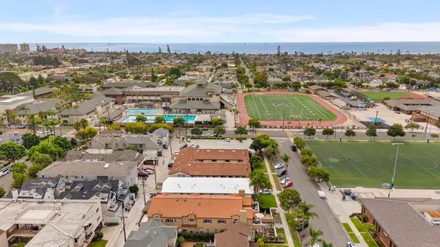 a view of a house with wooden deck and furniture