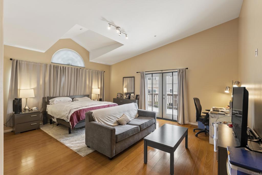 535 F Avenue, Unit 4 Coronado, CA 92118 - Photo 31 of 48 a spacious bedroom with a bed and wooden floor