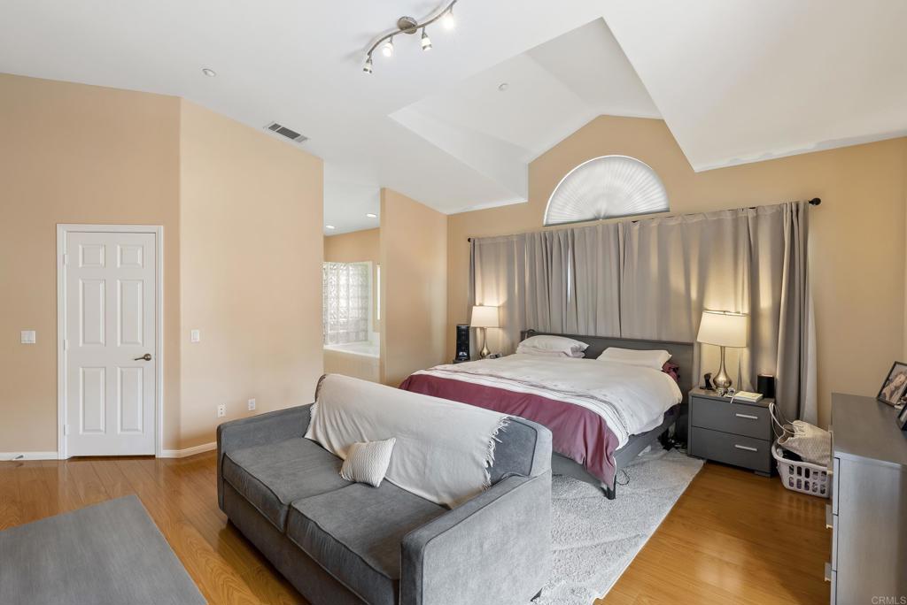 535 F Avenue, Unit 4 Coronado, CA 92118 - Photo 33 of 48 a bedroom with a bed and wooden floor