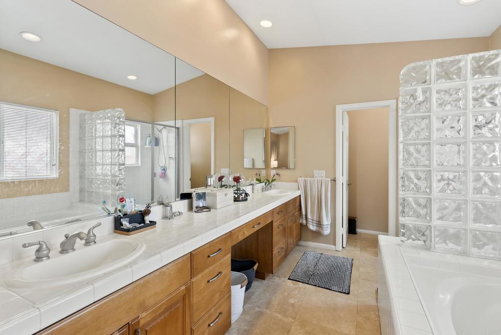 535 F Avenue, Unit 4 Coronado, CA 92118 - Photo 36 of 48 a bathroom with double vanity sinks a large mirror and a shower