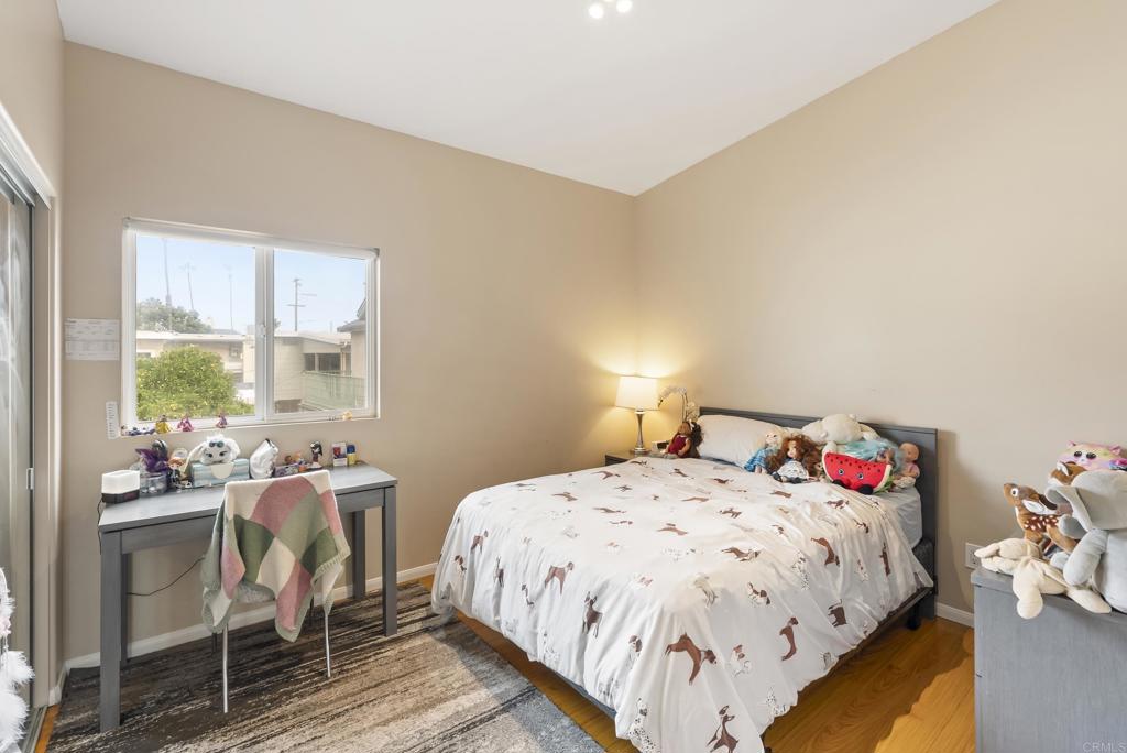 535 F Avenue, Unit 4 Coronado, CA 92118 - Photo 43 of 48 a bedroom with a bed and a table in it