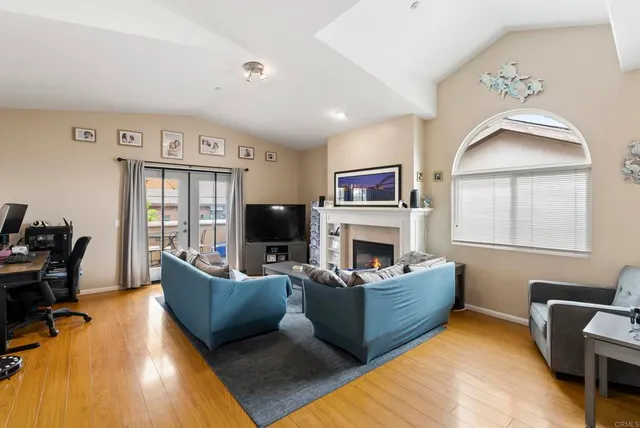 a living room with furniture a fireplace and a flat screen tv