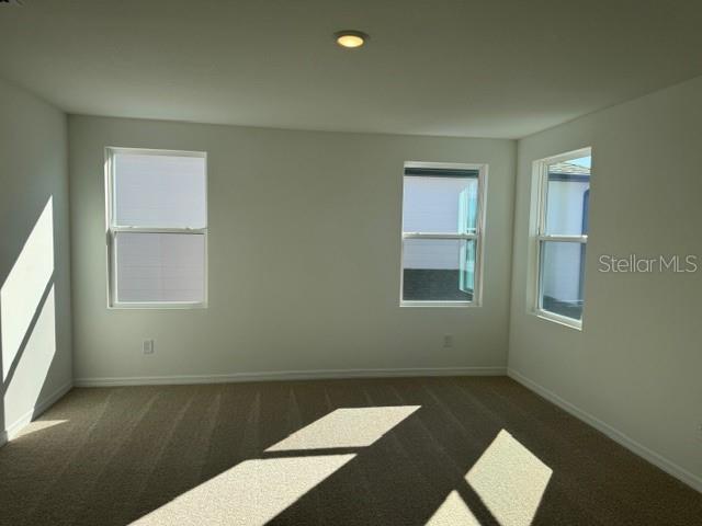 17727 Sharp Pummelo Alley Winter Garden, FL 34787 - Photo 13 of 19 a view of an empty room with a window