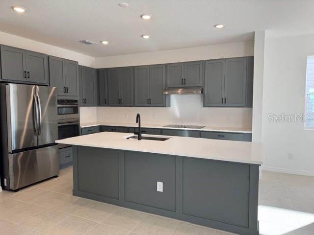 17727 Sharp Pummelo Alley Winter Garden, FL 34787 - Photo 4 of 19 a kitchen with kitchen island a sink stainless steel appliances and refrigerator