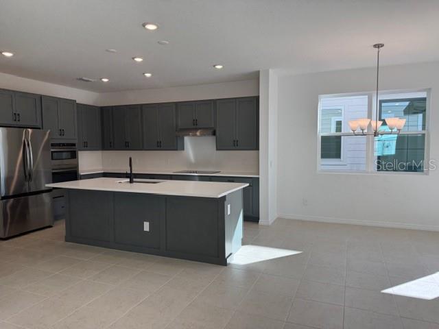17727 Sharp Pummelo Alley Winter Garden, FL 34787 - Photo 5 of 19 a kitchen with kitchen island a counter top space appliances and cabinets