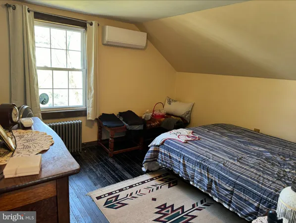 a bed sitting in a bedroom next to a window