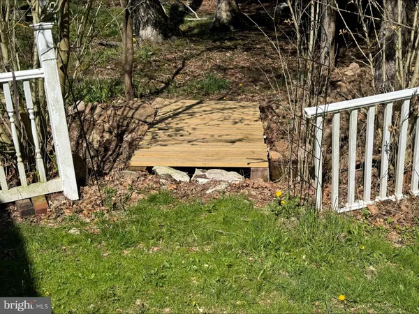 a view of backyard with garden and deck