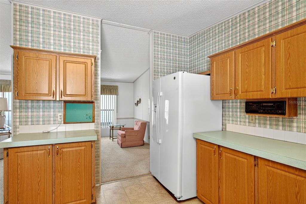 8046 Highpoint Boulevard Brooksville, FL 34613 - Photo 12 of 47 a white refrigerator freezer sitting inside of a kitchen