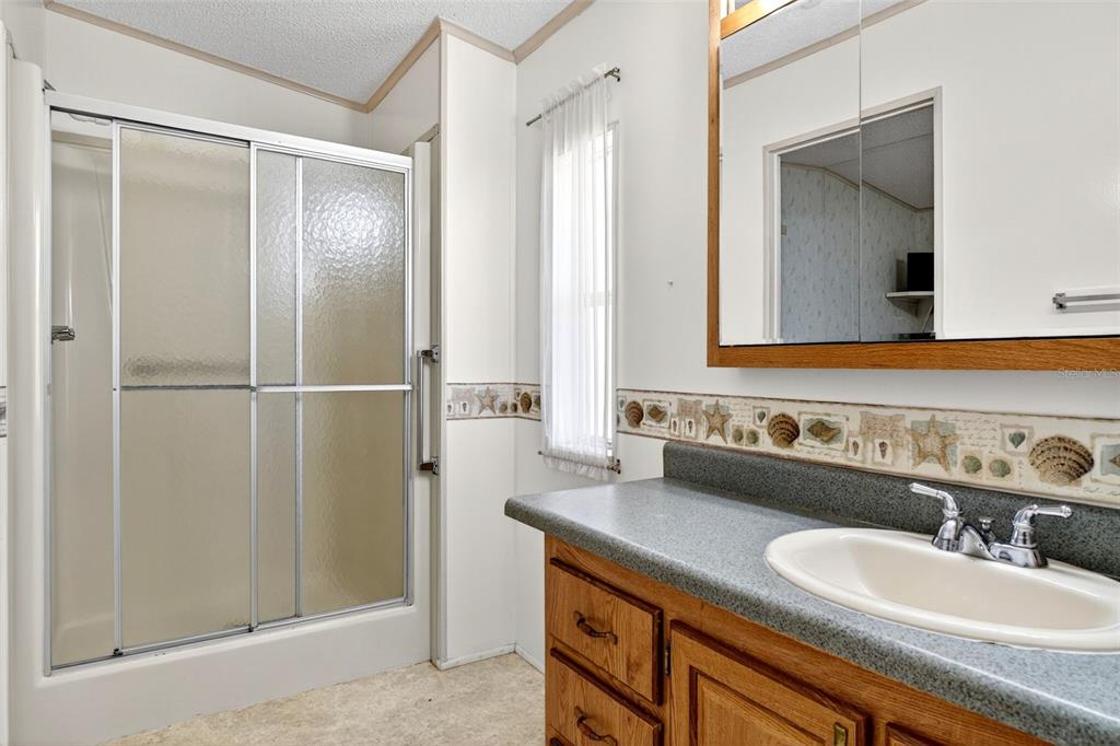 8046 Highpoint Boulevard Brooksville, FL 34613 - Photo 19 of 47 a bathroom with a granite countertop sink and a mirror
