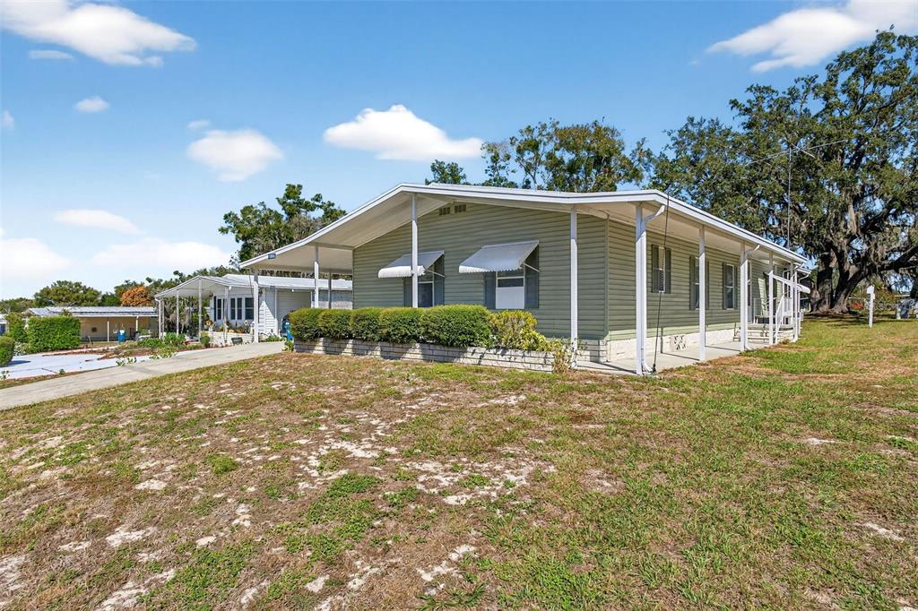 8046 Highpoint Boulevard Brooksville, FL 34613 - Photo 2 of 47 a front view of a house with a yard